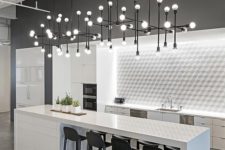 10 a lit up tile backsplash and several industrial chandeliers for lighting up the space
