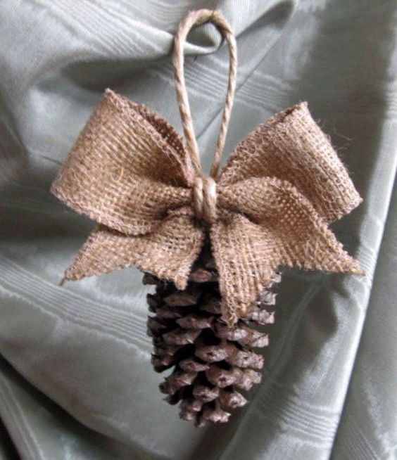 a burlap and pinecone ornament with twine for Christmas