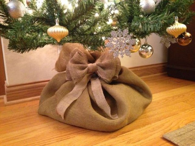 cover the base of your tree with a burlap sack and bows to make it cute and rustic