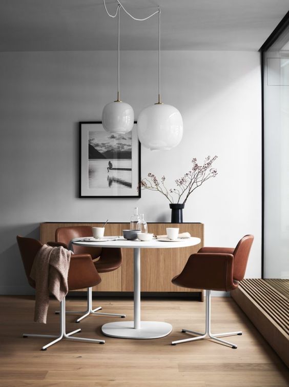 a Japanese-styled sideboard and some mid-century chairs upholstered with cognac leather