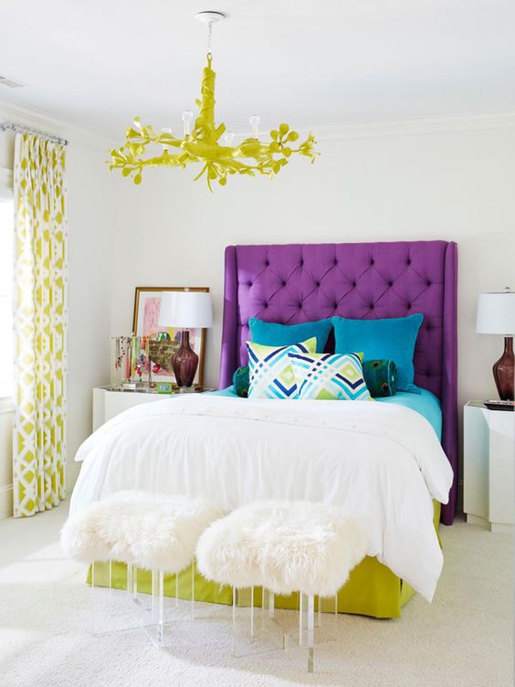 a colorful modern bedroom with a violet upholstered bed and pistachio touches