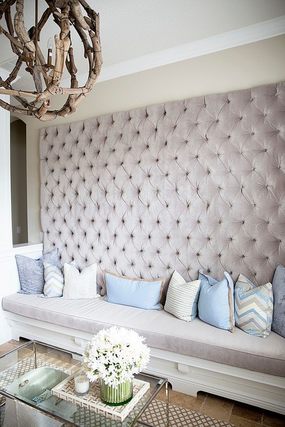 a whole wall upholstered with blush velvet guarantess a glam and girlish feel in the space
