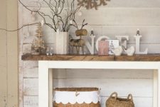 14 a rustic console with wooden and wicker decor, with letters and bracnesh in a cable knit vase