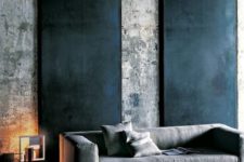 15 a moody space can be accentuated with blackened metal wall panels on raw concrete walls