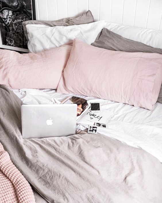 grey, white and pink bedding is great for a cozy pastel space