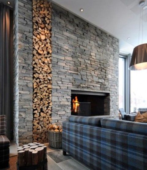 highlight your fireplace with a whole sone clad wall with firewood storage