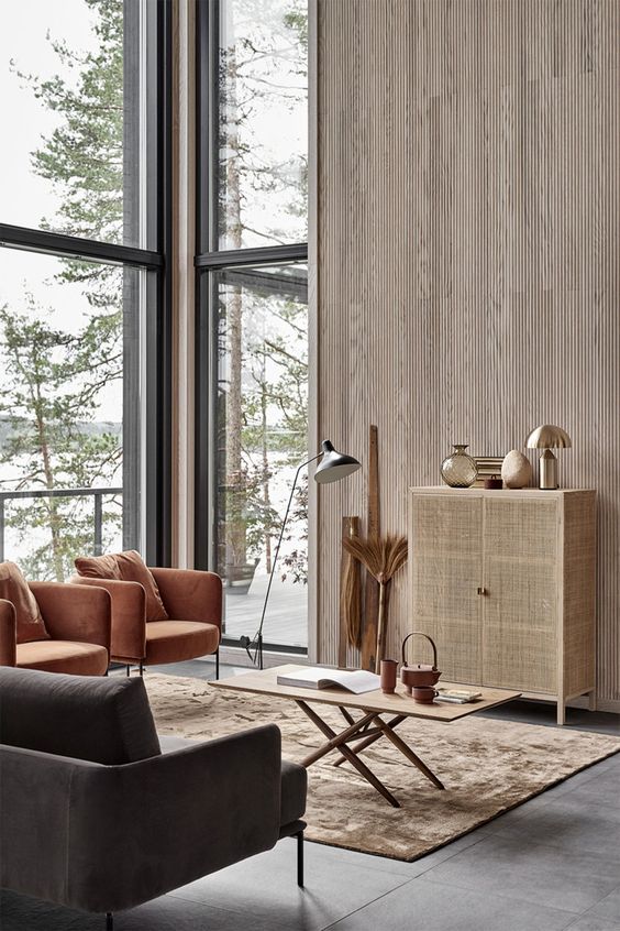 a simple bamboo cabinet and upholstered chairs in amber and grey