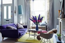 19 a violet upholstered sofa and a matching chandelier will add color to the space