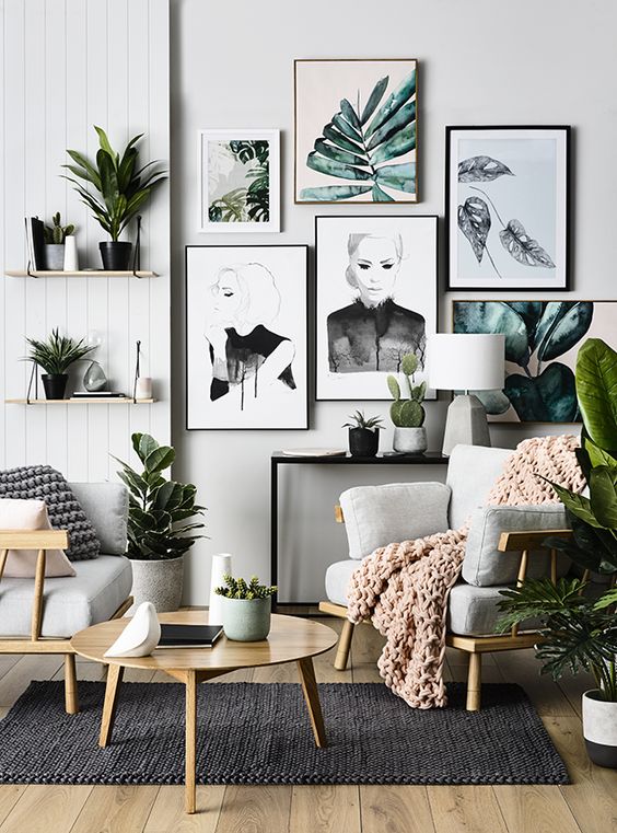 a gallery wall with tropical leaves that echo with real greenery around