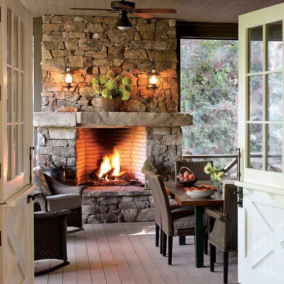 a stone clad fireplace with a stone mantel looks fantastic and is highlighted with a couple of lamps