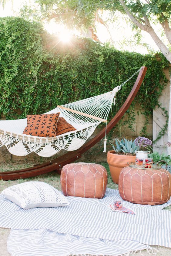 add an exotic feel to your outdoor space with a hammock and a couple of leather Moroccan-styled poufs