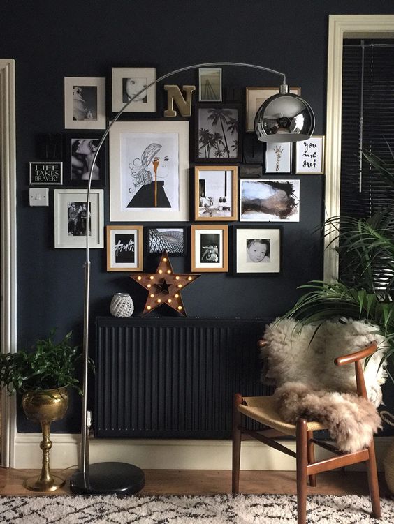 a chic gallery wall for a reading nook and a black radiator that looks invisible on a black wall