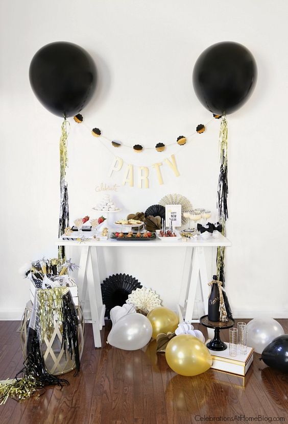 colorful fringe and black, gold and white balloons around will make any space party-like