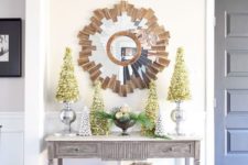21 metallic trees and a bowl with evergreens and ornaments for a chic look
