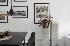 21 the space is accentuated with grey stone stands and a potted plant
