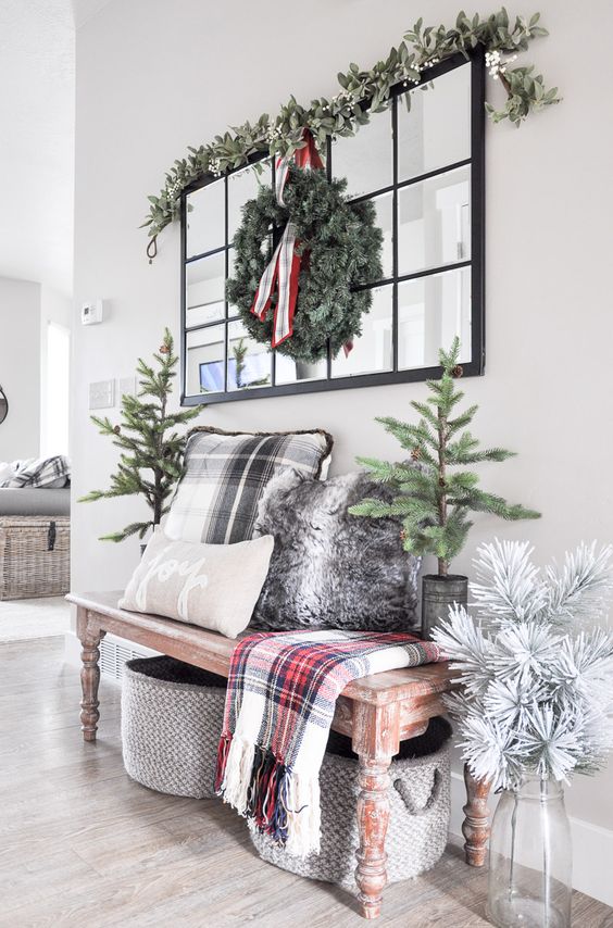 a eucalyptus garland and a faux evergreen wreath is all you need for an entryway
