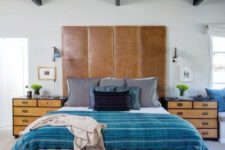 23 a large brown leather headboard is used as an eye-catcher in this vivacious space