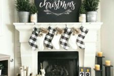23 buffalo check stockings and evergreens in buckets for a chic farmhouse mantel