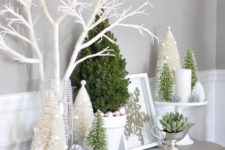 24 Christmas trees, ornaments, a succulent and candles for snowy styling
