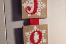 24 a JOY burlap sign with snowflakes and red letters will decorate any door or mantel