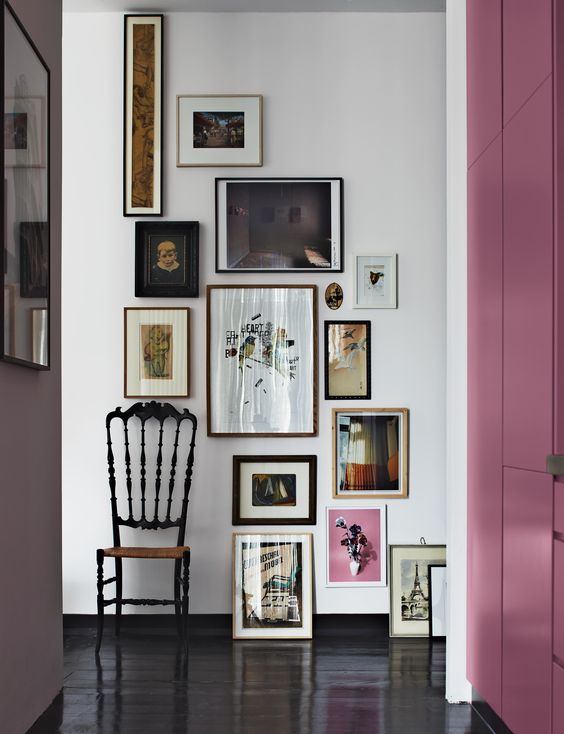 a create artwork arrangement in a vintage entryway with artworks placed on the floor, too