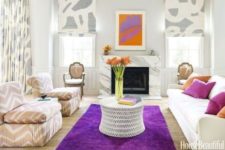 26 a violet rug and pillows to add a colorful touch to the neutral space