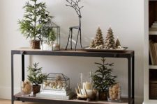 27 terrariums with faux snow and ornaments, evergreen trees in baskets and tree-shaped candles look quirky