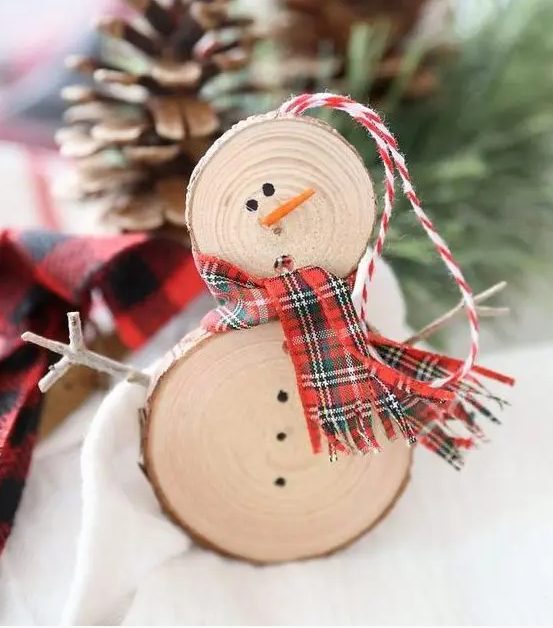 a rustic snowman ornament of wood slices, a plaid scarf and some sticks is ideal for Christmas