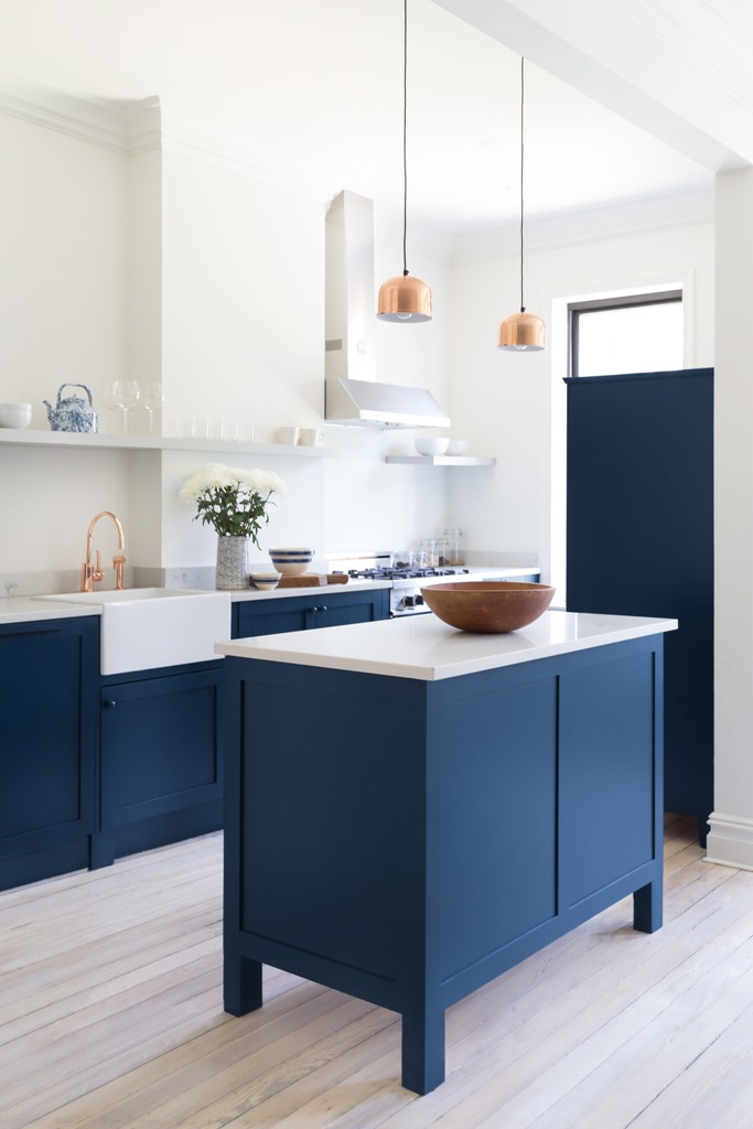 marble kitchen decor The kitchen was decorated with bold blue cabinets with marble countertops and glam was added with brass and copper touches