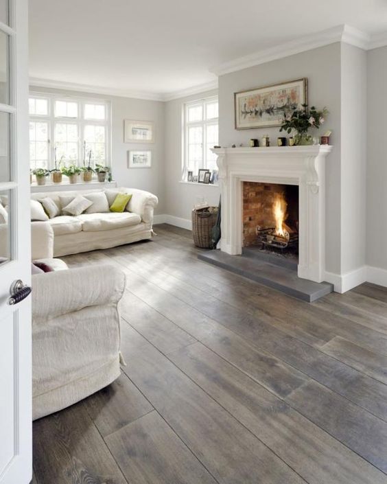chic dark laminate floors for a whitewashed living room to create a contrast