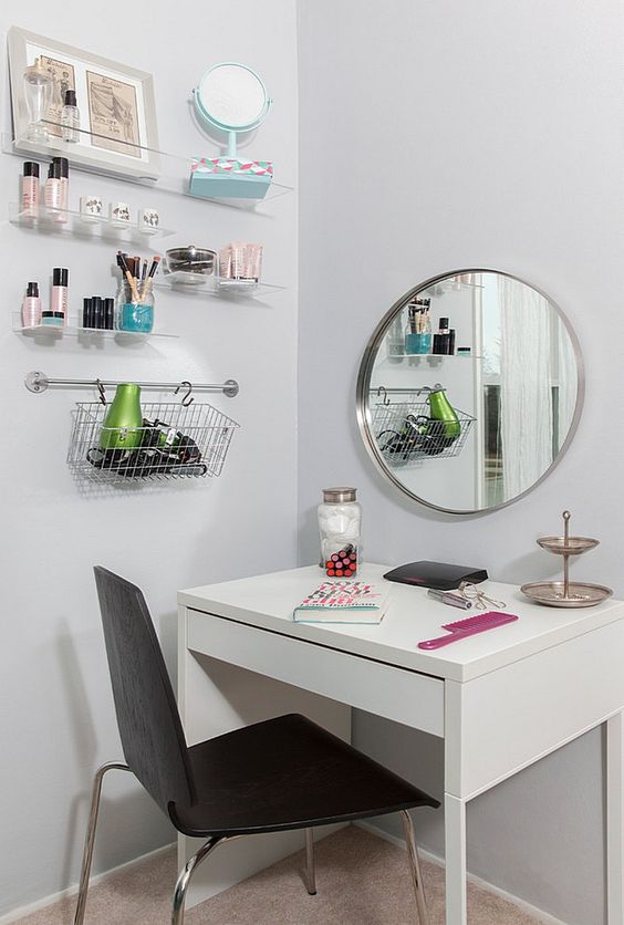 a functional makeup space with a Micke desk, a comfy chair, some wall mounted shelves and a large mirror