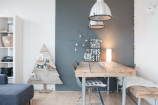 04 The dining space features a reclaimed wood and pipe dining set