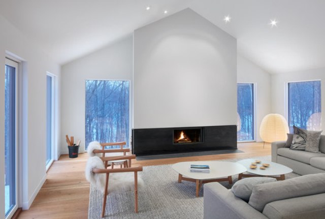 cool fireplace wall design The living zone is done with many windows to enjoy the views, a separate fireplace wall as a centerpiece