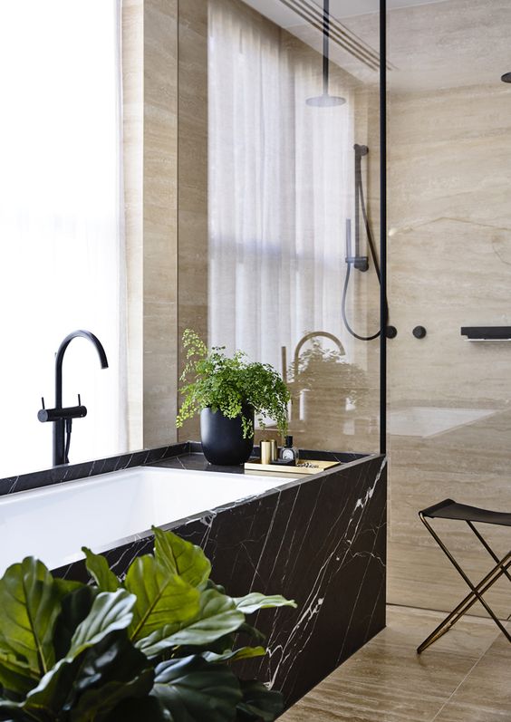 a spa feel can be added with materials used, for example, a bathtub clad with black marble