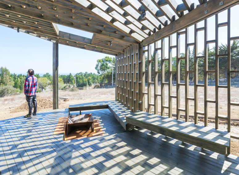 an outdoor seating area with a fire pit Benches come along the shell, and there's a fire pit, so this deck is a great outdoor space to spend time