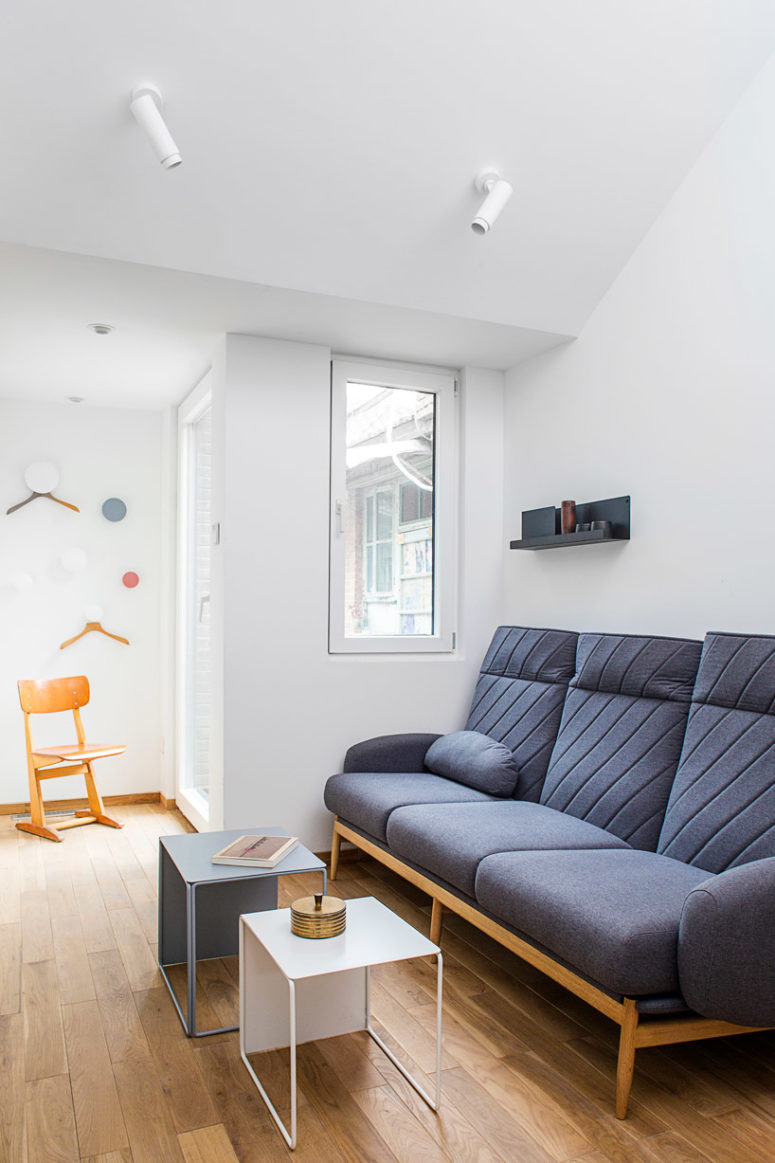 The living room and bedroom in one features simple modern furniture and high quality windows to keep the air clean