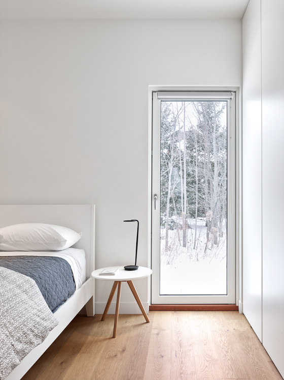 minimalist nightstands The master bedroom is decorated very simply with a comfy bed, nightstands and a glass door to outdoors