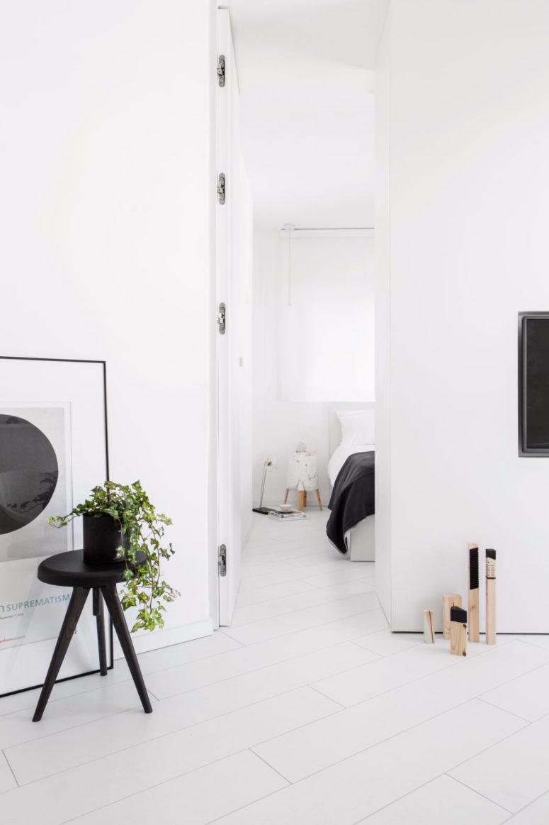 The smart wall between the living room and bedroom features a TV on one side and a wardrobe on the other side The smart wall between the living room and bedroom features a TV on one side and a wardrobe on the other side
