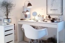 05 a chic makeup nook done in Scandinavian style, with a lamp and several mirrors, makeup stored in a drawer unit