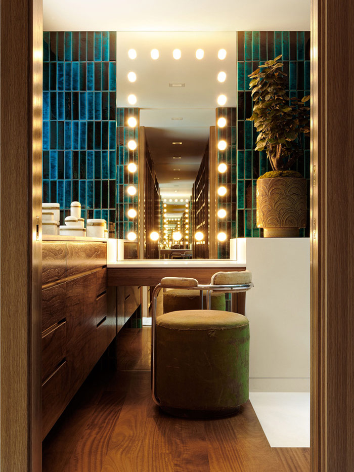 gorgeous makeup nook One of the bathrooms includes a makeup nook with a lit-up mirror and a comfy upholstered chair