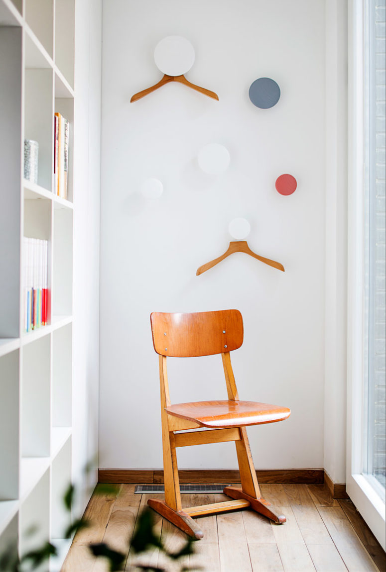 The hooks are colorful and round, they make clothes storage fun and there are bookshelves next to it