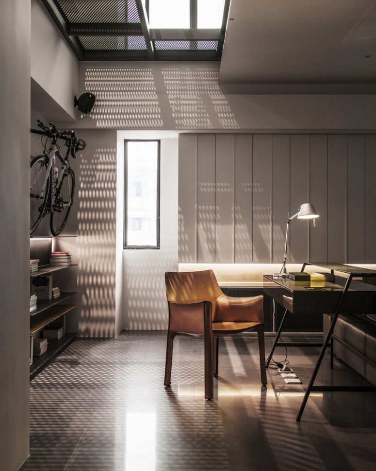 The metal mesh screen marks an opening in the ceiling and lets light run through, creating a pattern on the floor The metal mesh screen marks an opening in the ceiling and lets light run through, creating a pattern on the floor