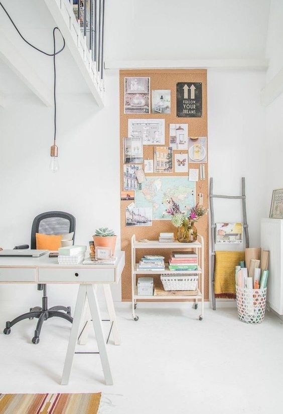 a tall cork pinboard that goes up to the ceiling yet doesn't take much space