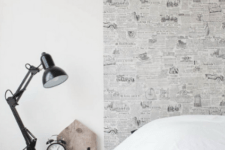 07 The headboard wall is enlivened with newspaper-like wallpaper