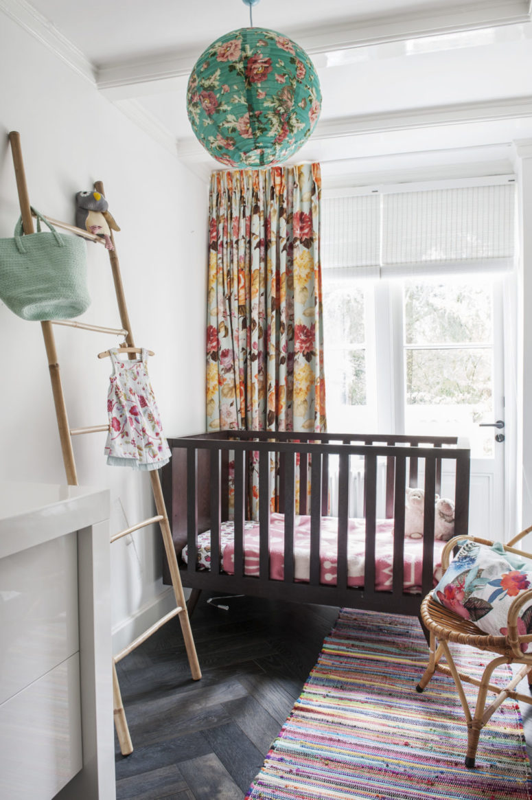 The kid's space is done with floral textiles, a striped rug and looks very lively and colorful - exactly what a small girl needs