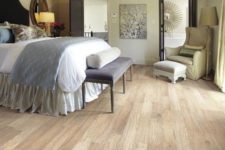 07 a vintage-styled bedroom with an elegant feel and laminate flooring, which looks like wood