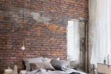 07 an exposed brik wall is a great idea for a masculine bedroom or an industrial space