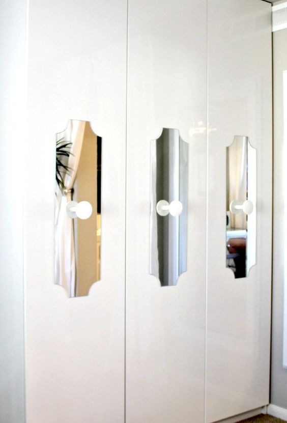 cutout mirror touches with white knobs add interest to a Pax wardrobe