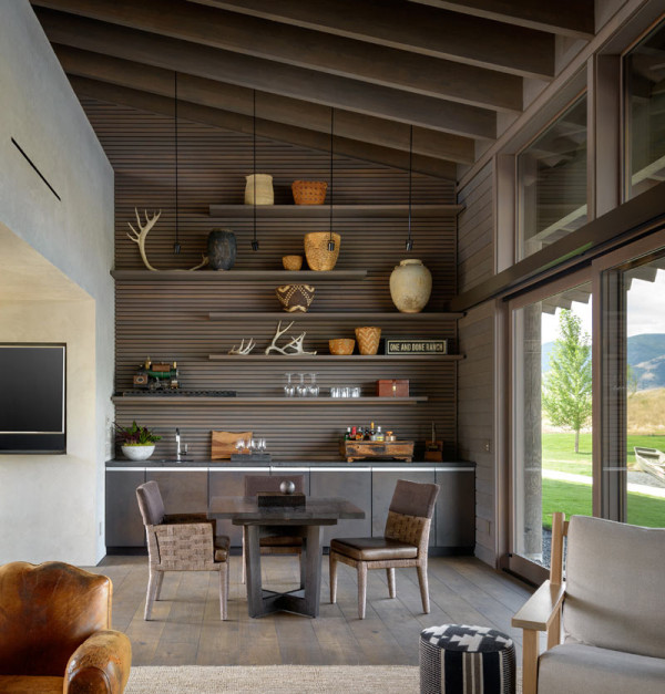 This is a breakfast space with floating shelves and a mid-century modern dining set