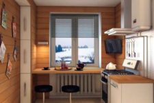 08 a small kitchen clad with wood and a windowsill bar with modern stools and a view
